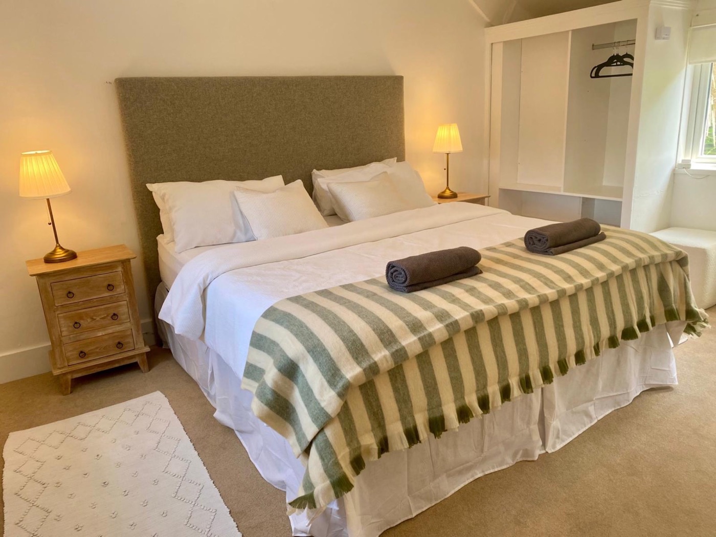 Calm king bedroom with crisp white linen and green accents