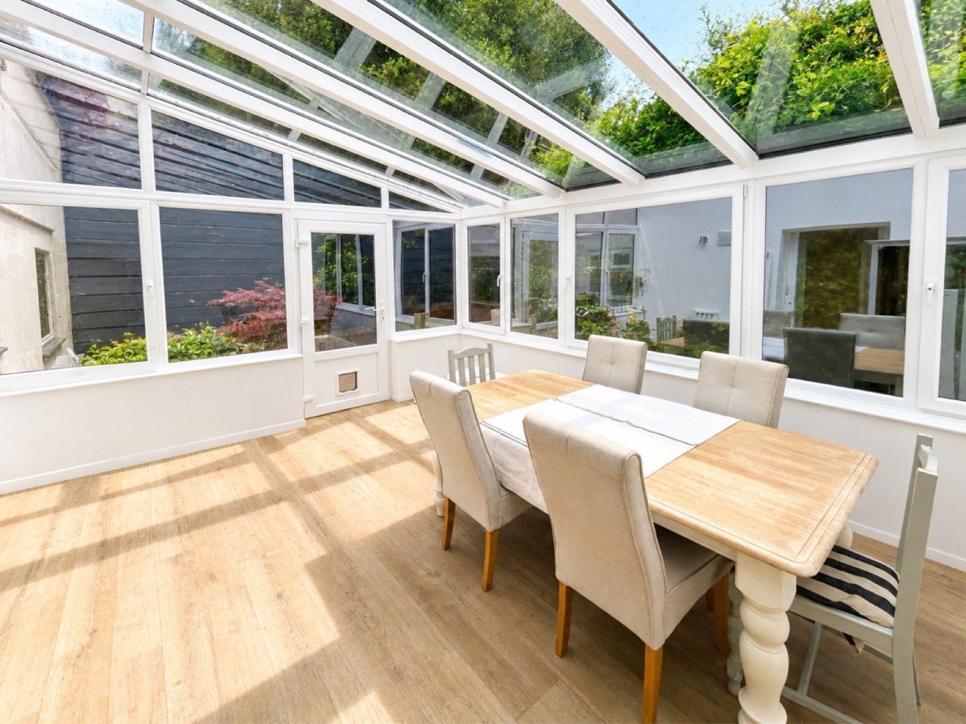 Sunlit conservatory dining room at The Coach House