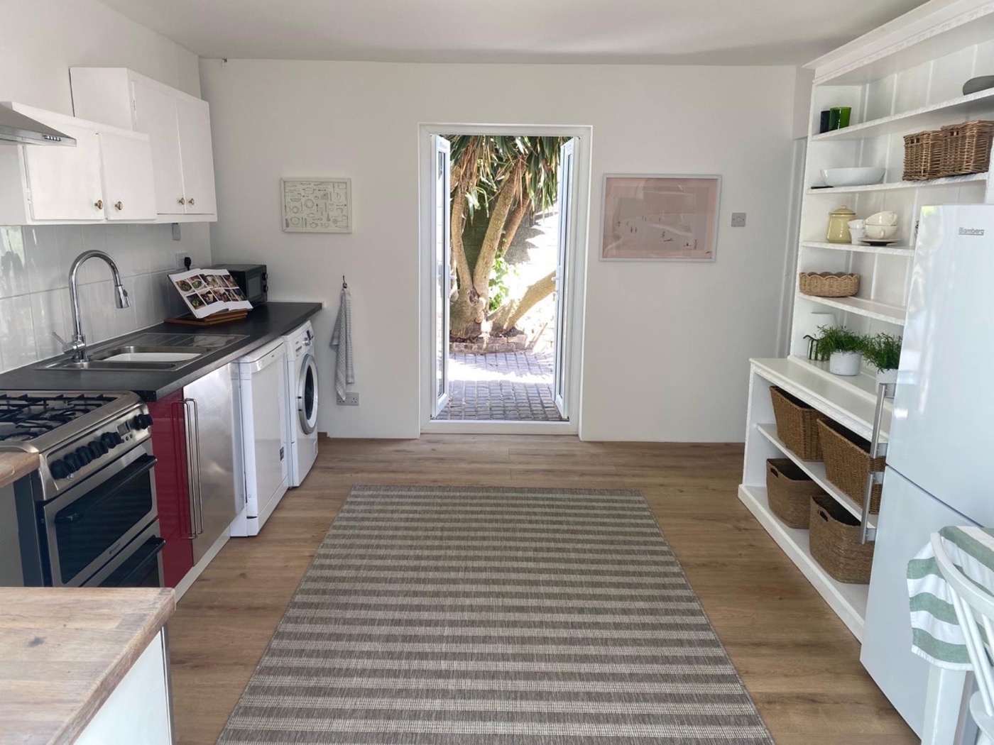 The Coach House kitchen with an open door to the garden